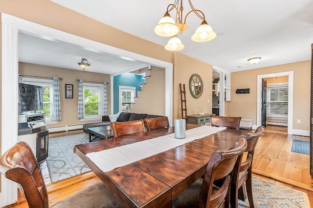 15 N St, Warwick, RI 02886 - dining area featuring light wood-style floors, a chandelier, and a baseboard radiator