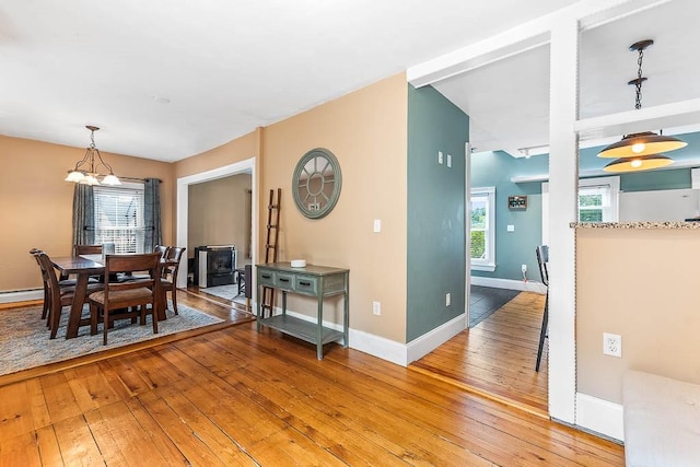 15 N St, Warwick, RI 02886 - dining space with light wood-style flooring, a chandelier, and a wood stove