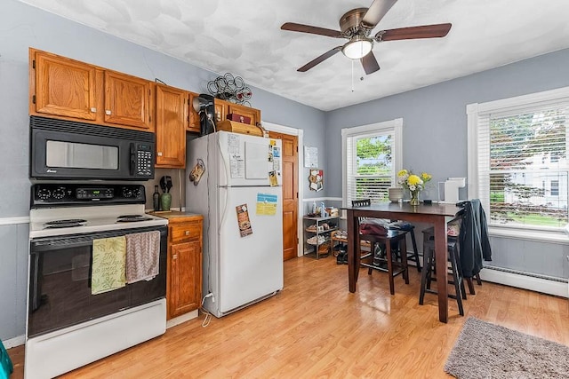 15 N St, Warwick, RI 02886 - kitchen featuring freestanding refrigerator, black microwave, electric stove, a baseboard heating unit, and light wood-type flooring