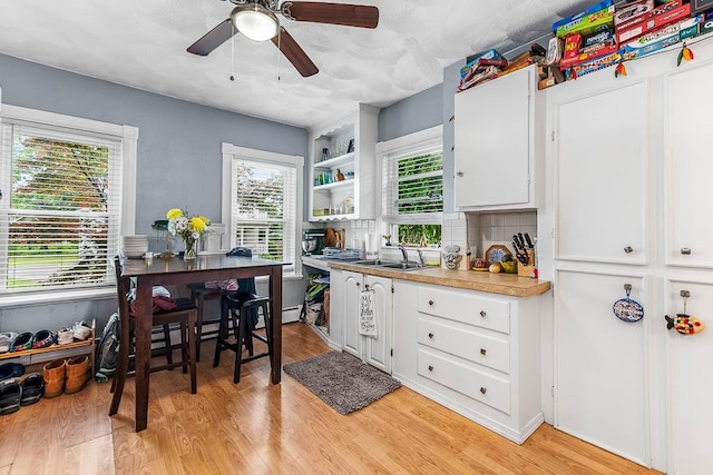 15 N St, Warwick, RI 02886 - kitchen with white cabinetry, ceiling fan, light wood-style flooring, light countertops, and open shelves