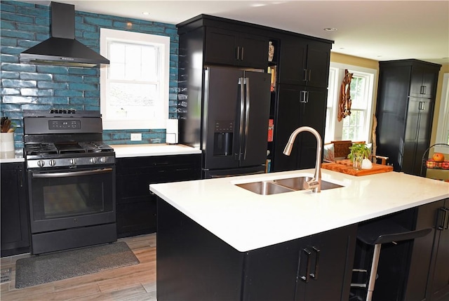 2352 Matunuck Schoolhouse Rd, Charlestown, RI 02813 - kitchen with wall chimney range hood, range with gas stovetop, fridge with ice dispenser, dark cabinets, and light countertops