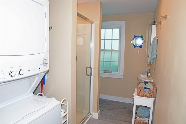 2352 Matunuck Schoolhouse Rd, Charlestown, RI 02813 - washroom featuring stacked washer and clothes dryer and wood finished floors