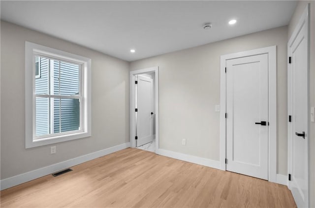 137 Stanwood St, Providence, RI 02907 - unfurnished bedroom with light wood-type flooring and recessed lighting