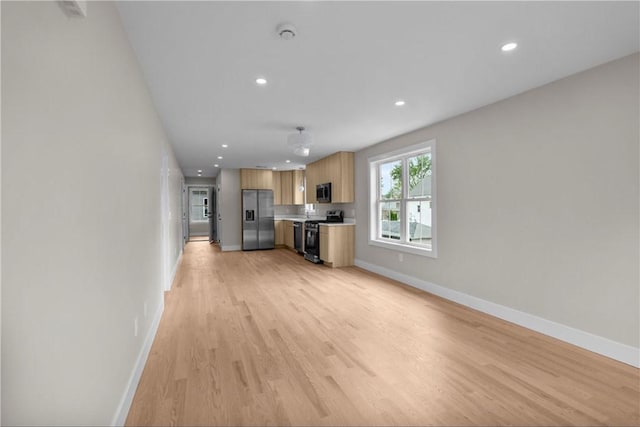 137 Stanwood St, Providence, RI 02907 - unfurnished living room featuring light wood-type flooring and recessed lighting