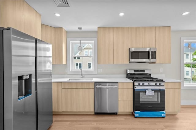137 Stanwood St, Providence, RI 02907 - kitchen featuring stainless steel appliances, light brown cabinets, modern cabinets, and recessed lighting