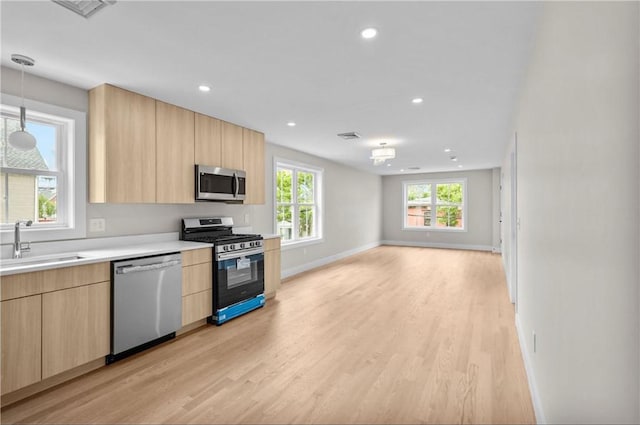 137 Stanwood St, Providence, RI 02907 - kitchen with appliances with stainless steel finishes, light brown cabinetry, modern cabinets, light wood-type flooring, and recessed lighting