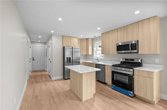 137 Stanwood St, Providence, RI 02907 - kitchen with stainless steel appliances, light brown cabinets, light wood-type flooring, a center island, and recessed lighting