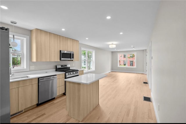 137 Stanwood St, Providence, RI 02907 - kitchen with appliances with stainless steel finishes, light brown cabinetry, modern cabinets, light wood-style flooring, and recessed lighting