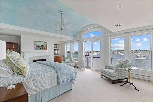19 Defenders Row Unit 19, Newport, RI 02840 - carpeted bedroom featuring access to outside, a chandelier, lofted ceiling, a fireplace, and a water view