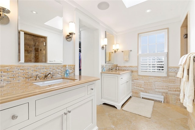 19 Defenders Row Unit 19, Newport, RI 02840 - bathroom featuring two vanities, wainscoting, recessed lighting, tile walls, and tile patterned floors