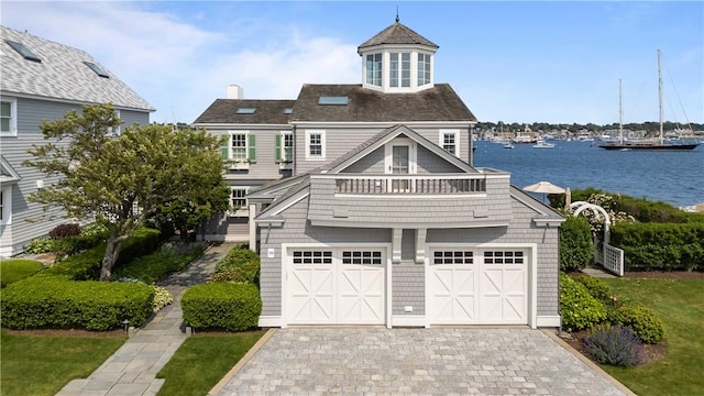 19 Defenders Row Unit 19, Newport, RI 02840 - view of front facade with a balcony, decorative driveway, a water view, a chimney, and an attached garage