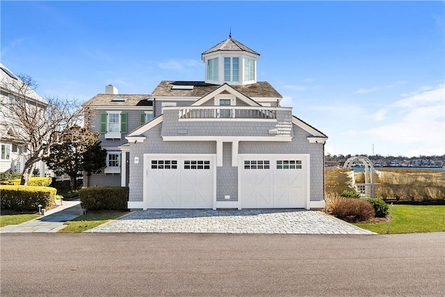 19 Defenders Row Unit 19, Newport, RI 02840 - view of front of house with a garage, driveway, a balcony, and a chimney