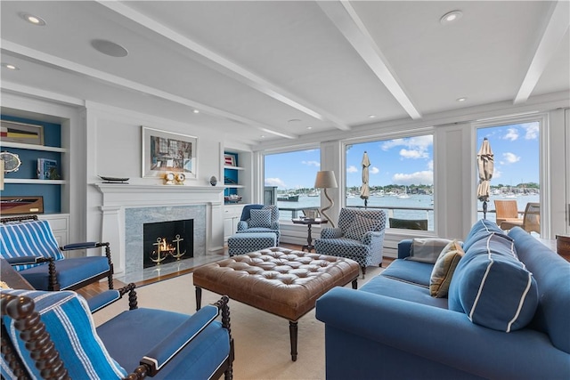 19 Defenders Row Unit 19, Newport, RI 02840 - living room with a premium fireplace, beam ceiling, built in shelves, and a water view