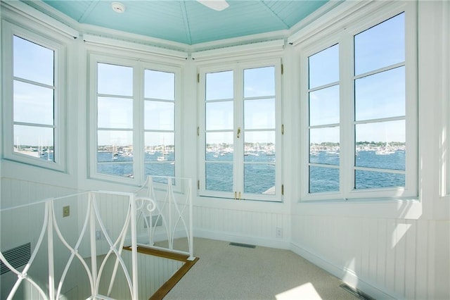 19 Defenders Row Unit 19, Newport, RI 02840 - unfurnished sunroom featuring a water view and carpet flooring