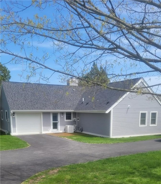 318 Corey Ln Unit 318, Middletown, RI 02842 - view of front of property featuring driveway, an attached garage, a shingled roof, and a chimney