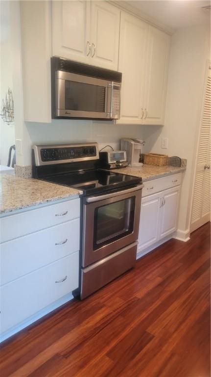 318 Corey Ln Unit 318, Middletown, RI 02842 - kitchen with appliances with stainless steel finishes, white cabinets, dark wood-style flooring, and light stone countertops