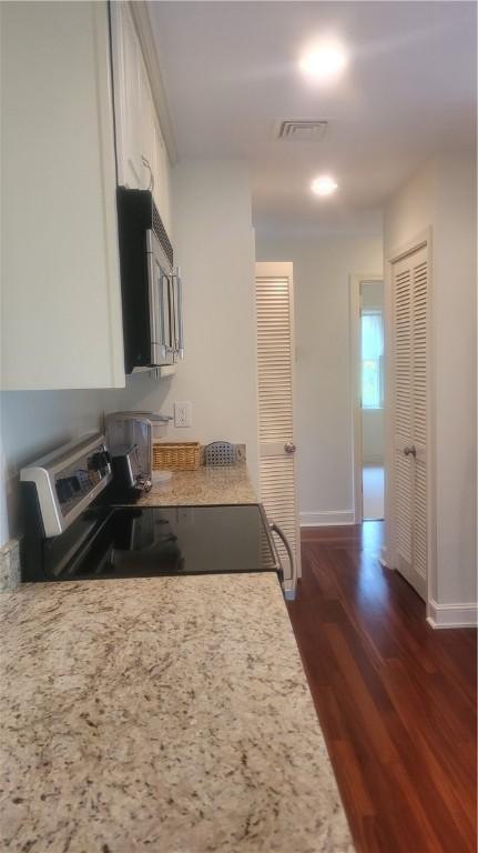 318 Corey Ln Unit 318, Middletown, RI 02842 - kitchen featuring stainless steel electric stove, dark wood finished floors, white cabinets, and light countertops