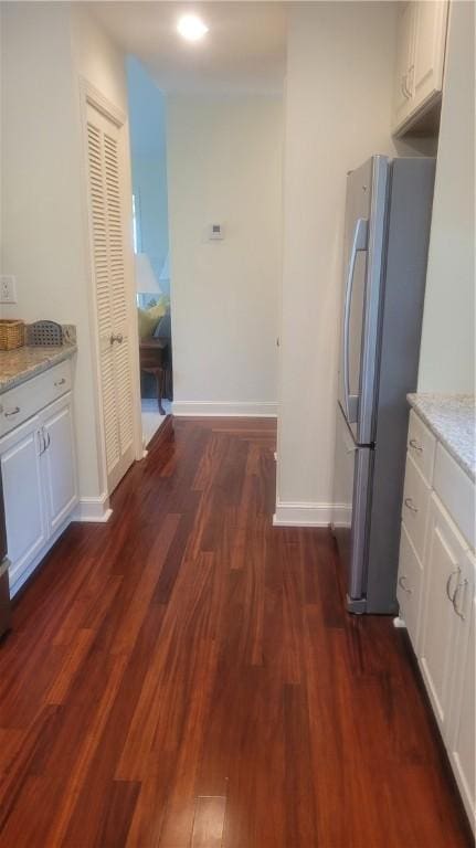 318 Corey Ln Unit 318, Middletown, RI 02842 - kitchen with freestanding refrigerator, dark wood-type flooring, white cabinetry, and light stone countertops