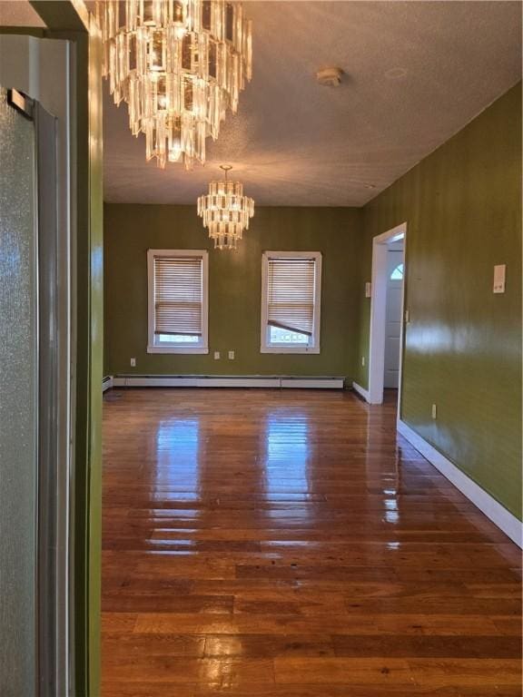 133 Byfield St, Providence, RI 02905 - unfurnished dining area featuring a chandelier, hardwood / wood-style flooring, and a baseboard heating unit