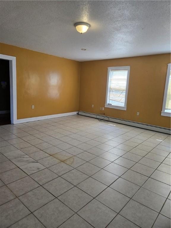 133 Byfield St, Providence, RI 02905 - spare room with a baseboard heating unit, a textured ceiling, and light tile patterned flooring