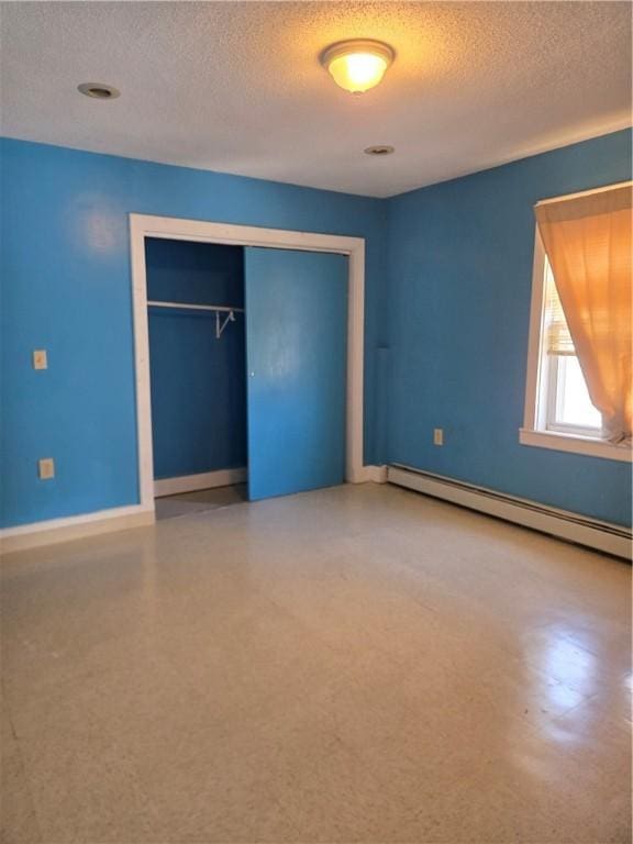133 Byfield St, Providence, RI 02905 - unfurnished bedroom with a baseboard heating unit, a textured ceiling, and a closet