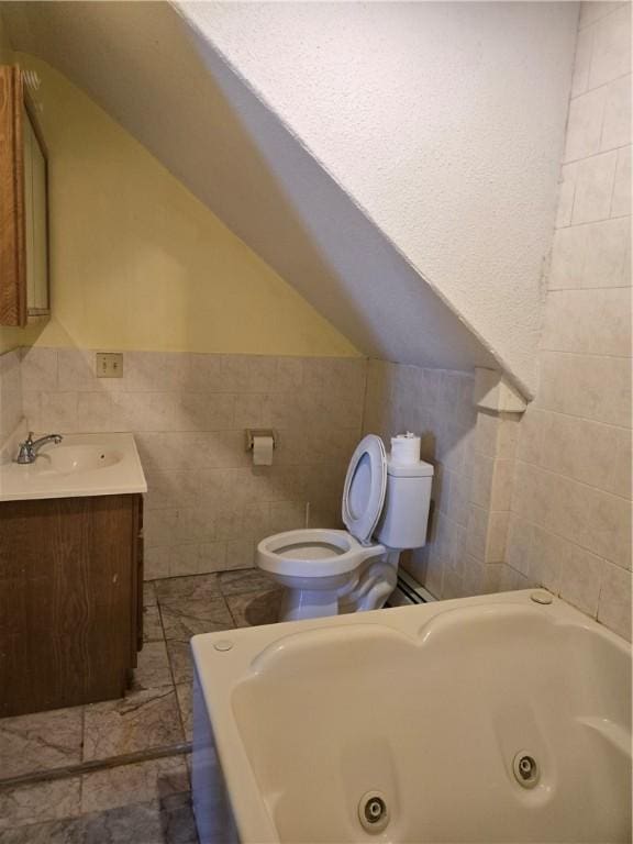 133 Byfield St, Providence, RI 02905 - full bathroom featuring tile walls, a jetted tub, vanity, and vaulted ceiling