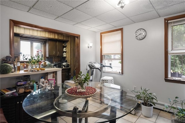 35 Fountain St, Pawtucket, RI 02860 - dining space with light tile patterned flooring, a paneled ceiling, and a baseboard heating unit