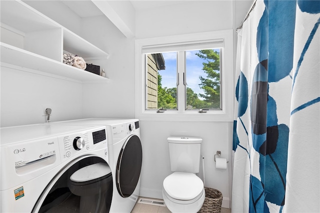 267 Fishing Cove Rd, North Kingstown, RI 02852 - laundry area featuring washer and dryer and light tile patterned floors