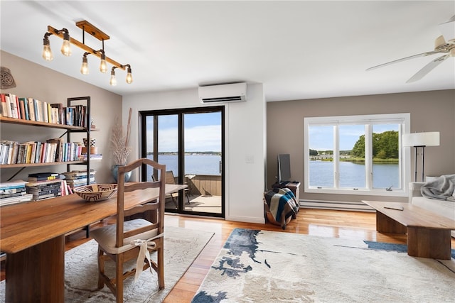 267 Fishing Cove Rd, North Kingstown, RI 02852 - office with a wall mounted air conditioner, light wood-type flooring, a baseboard heating unit, and ceiling fan
