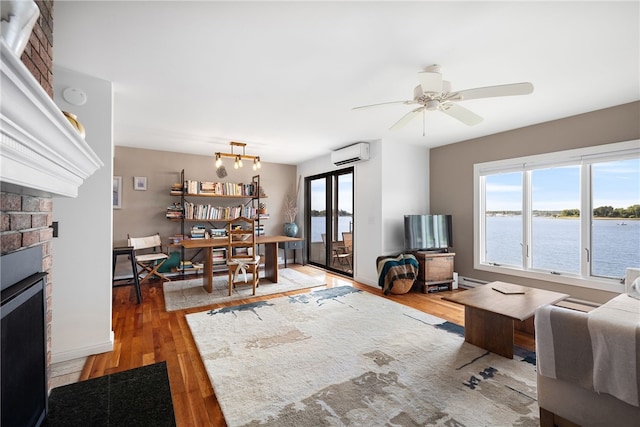 267 Fishing Cove Rd, North Kingstown, RI 02852 - living area featuring a wall mounted AC, a fireplace, plenty of natural light, and a desk