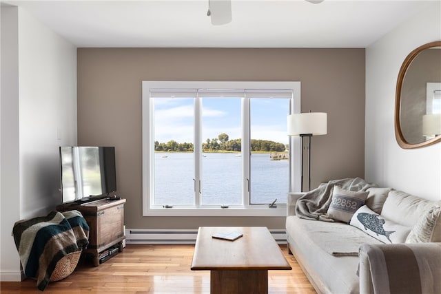 267 Fishing Cove Rd, North Kingstown, RI 02852 - living room featuring plenty of natural light, light wood-style floors, and a baseboard heating unit
