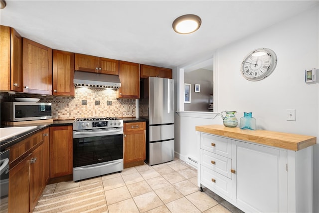 267 Fishing Cove Rd, North Kingstown, RI 02852 - kitchen featuring appliances with stainless steel finishes, under cabinet range hood, backsplash, and brown cabinetry