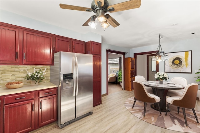 4 S Cornell Ave, Warren, RI 02885 - kitchen featuring stainless steel refrigerator with ice dispenser, reddish brown cabinets, decorative backsplash, ceiling fan, and light wood-type flooring
