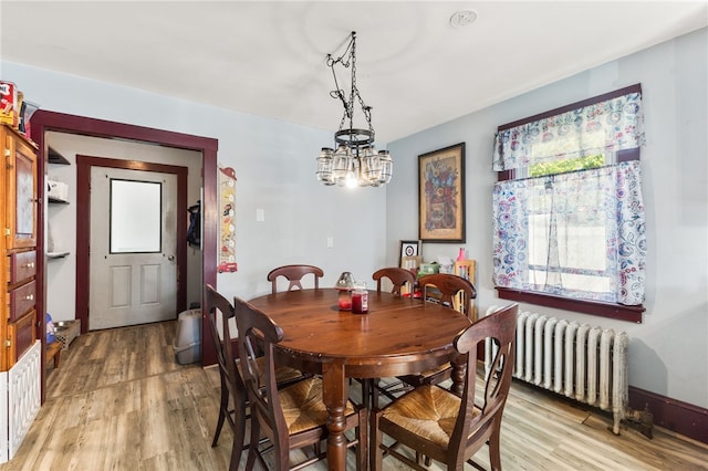 4 S Cornell Ave, Warren, RI 02885 - dining space with radiator, light wood-type flooring, and a chandelier