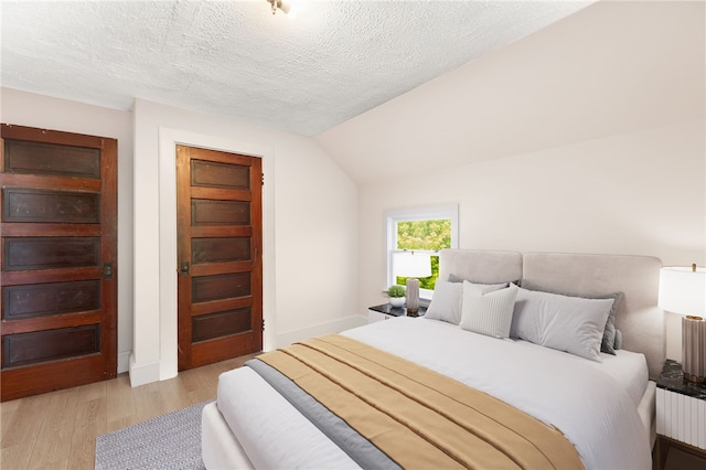 4 S Cornell Ave, Warren, RI 02885 - bedroom featuring light wood-style floors, lofted ceiling, and a textured ceiling