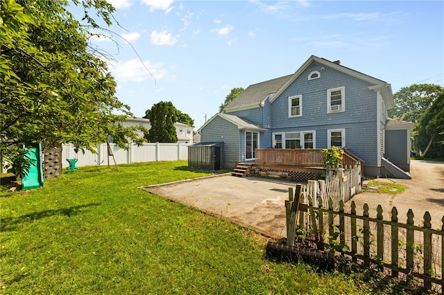 4 S Cornell Ave, Warren, RI 02885 - rear view of property featuring a deck, a storage shed, a fenced backyard, and a patio