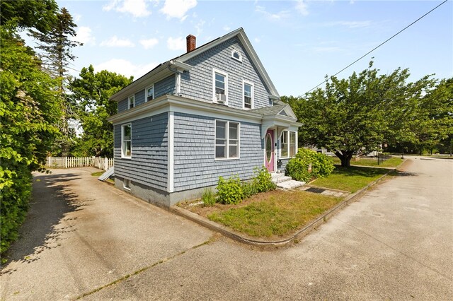 4 S Cornell Ave, Warren, RI 02885 - view of side of home featuring a chimney and asphalt driveway