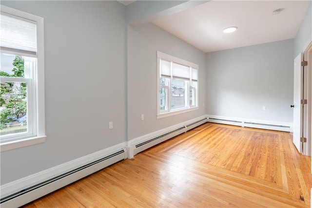 168 Waterman Ave, East Providence, RI 02914 - empty room with a baseboard heating unit, light wood finished floors, and a smoke detector