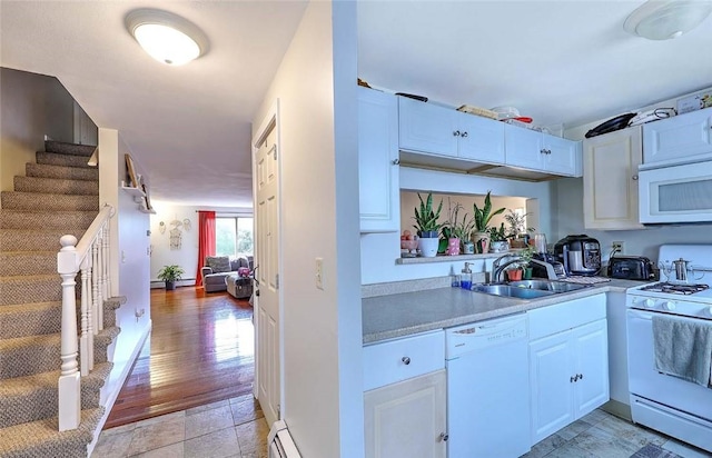 25 Sharon St Unit 1, Cranston, RI 02910 - kitchen with white appliances, light countertops, and white cabinetry