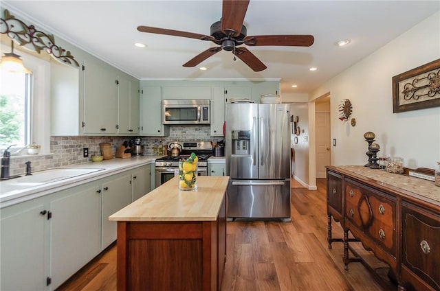 75 Columbus St, Providence, RI 02908 - kitchen with appliances with stainless steel finishes, wood counters, dark wood-type flooring, backsplash, and a ceiling fan