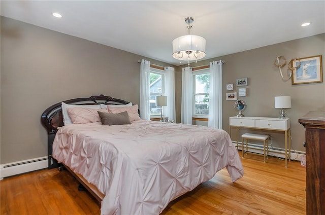 75 Columbus St, Providence, RI 02908 - bedroom featuring a baseboard heating unit, wood finished floors, and recessed lighting
