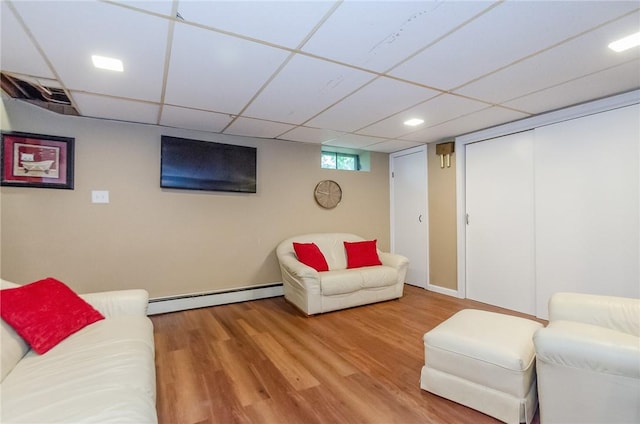 75 Columbus St, Providence, RI 02908 - living area featuring baseboard heating, wood finished floors, and a drop ceiling