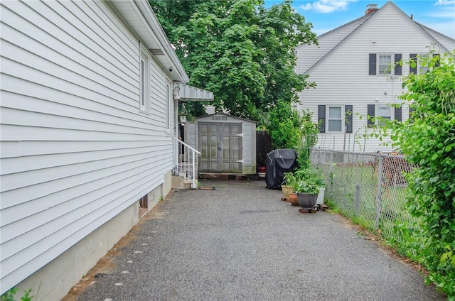 75 Columbus St, Providence, RI 02908 - view of side of home featuring a storage shed and a patio