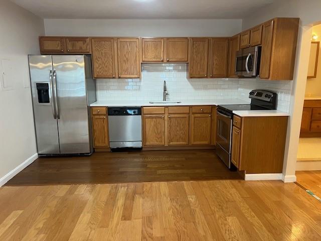 444 Woodward Rd Unit 3, North Providence, RI 02904 - kitchen with stainless steel appliances, dark wood-style floors, and brown cabinets