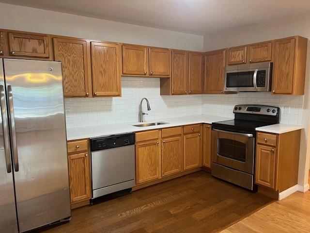444 Woodward Rd Unit 3, North Providence, RI 02904 - kitchen with stainless steel appliances, dark wood finished floors, light countertops, and tasteful backsplash