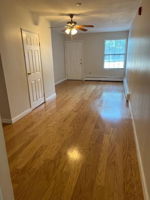 444 Woodward Rd Unit 3, North Providence, RI 02904 - spare room with wood finished floors, ceiling fan, and baseboard heating
