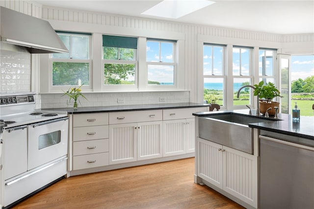 68 Grange Ave, Little Compton, RI 02837 - kitchen featuring white electric stove, extractor fan, dishwasher, a skylight, and decorative backsplash