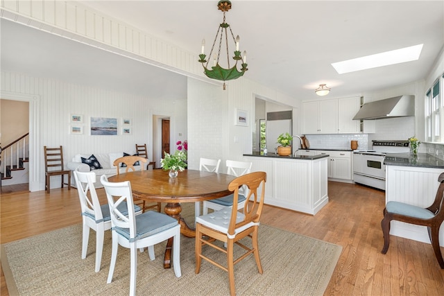 68 Grange Ave, Little Compton, RI 02837 - dining space featuring light wood-style flooring, healthy amount of natural light, a skylight, and stairway
