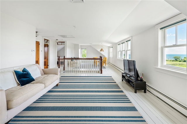 68 Grange Ave, Little Compton, RI 02837 - living area featuring a baseboard heating unit and wood finished floors