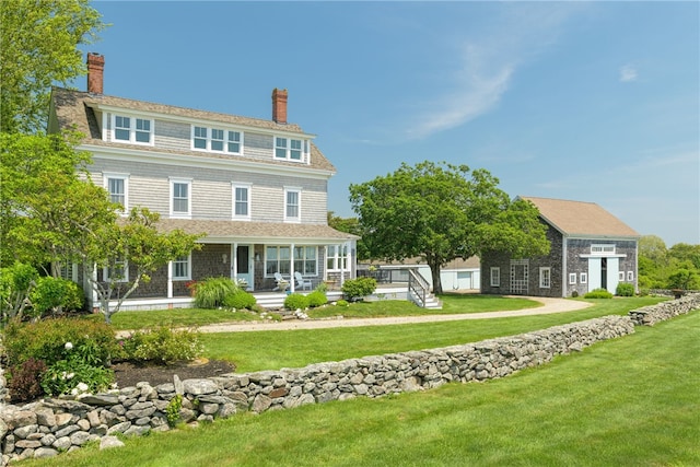 68 Grange Ave, Little Compton, RI 02837 - view of front of house with a chimney, a front lawn, and covered porch